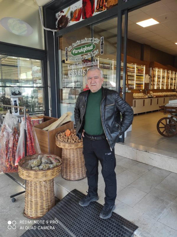 faruk efendi dükkanın önünde poz veriyor